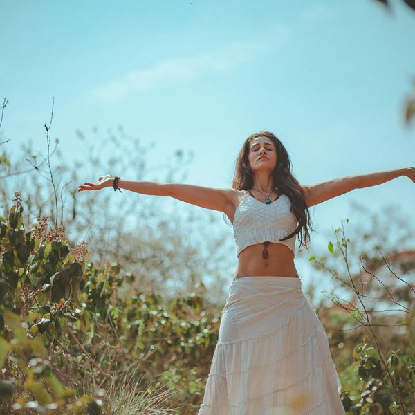 Person stretching in a calm, natural environment feeling well.